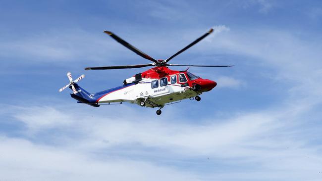 The QG Air 510 Rescue emergency services helicopter transports a 44 year old male spearfisherman to Cairns Hospital, after he was bitten multiple times by a 4.5 metre saltwater crocodile off Archer Point, south of Cooktown in Far North Queensland. Picture: Brendan Radke