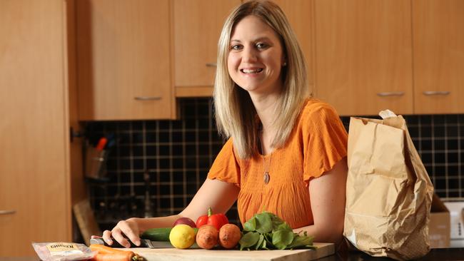 Laura Peters prepares food from a HelloFresh meal kit. Picture: Tait Schmaal