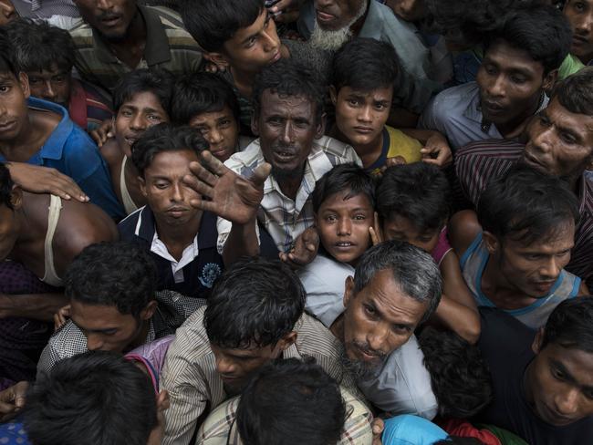 Rohingya refugees wait for sacks of rice to be distributed in Whaikhyang, Bangladesh after violence erupted in Rakhine state. Picture: Dan Kitwood/Getty Images