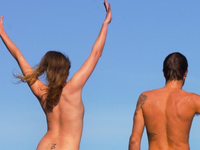 Pic from Get Naked Australia/Caters News - (Pictured: Photos of scantily clad hikers posing in front of stunning Australian landscapes have been released. This one was photographed in the ocean.) - An Aussie who created a joke nude calendar for his girlfriend is now sent DOZENS of naked snaps daily after launching a cheeky social media bum-baring craze. Healthcare professional Brendan Jones is now regularly inundated with photos of scantily clad hikers posing in front of stunning Australian landscapes. The 27-year-old, from Sydney, now regularly poses for barely-there snaps when out on walks with friends and the body positivity stunt has racked up thousands of fans. SEE CATERS COPY