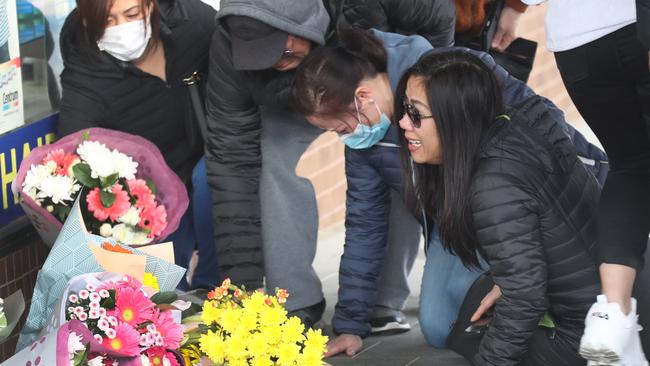 Mr Tran’s distraught mother laying flowers where he died. Picture: David Crosling