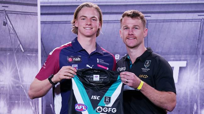 Miles Bergman (left) is presented with his guernsey from Power star Robbie Gray. Picture: AAP Image/Michael Dodge