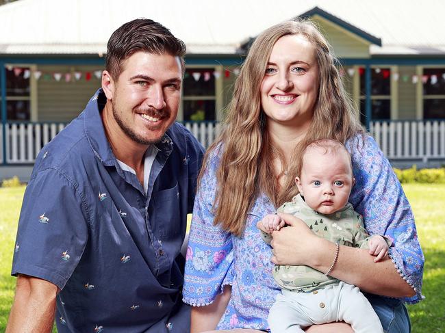 WEEKEND TELEGRAPHS SPECIAL. DECEMBER 10, 2022. PLEASE CONTACT WEEKEND PIC EDITOR JEFF DARMANIN BEFORE PUBLISHING.Pictured at home in Meroo Meadow today is Hayley and Ben Oakley, with their three month old baby son Arthur, who was born via surrogate after a long and difficult journey to parenthood. Picture: Tim Hunter.