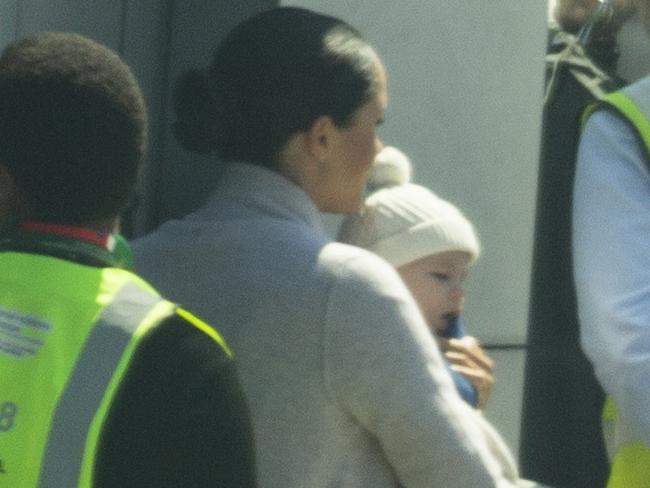 The family took a British Airways flight and Meghan carried baby Archie off the plane.