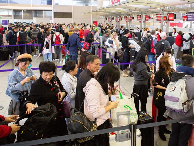 7/10/18 Growing crowds wait in frustration as flights are cancelled or delayed due to a shortage of staff in air traffic control.Picture: Luke Drew