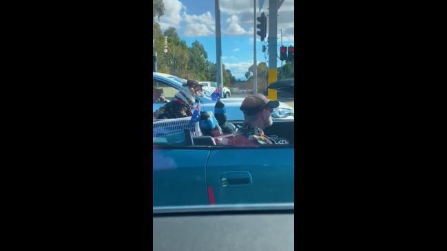 Cool Aussie man and dog ride in matching outfits