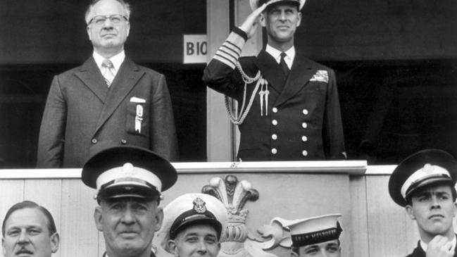 Prince Philip takes the salute as the parade of teams enter the stadium during the Opening Ceremony of the 1956 Olympics.