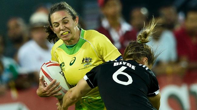 Chloe Dalton of Australia is tackled by Michaela Blyde of New Zealand in Dubai.