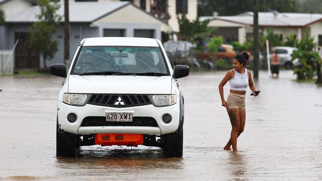 A four wheel drive ute escapes the flood waters on Campbell Street, after heavy rain caused flooding to some areas in Gordonvale. Picture: Brendan Radke