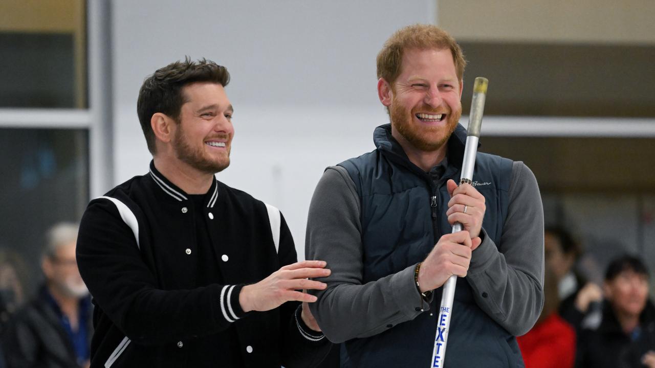 Michael Buble laughs with Prince Harry. Picture: Karwai Tang/WireImage