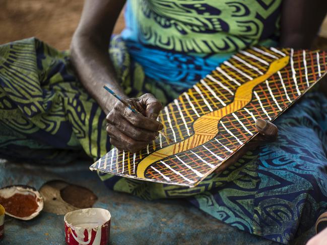 An Aboriginal artist painting at Tiwi Design.Tiwi Tours specialise in exclusive Aboriginal cultural tours on Bathurst Island and provide travellers with the unique opportunity to explore a modern day Aboriginal community, where you can learn about art, bush tucker and the history and culture of the Tiwi people.Tiwi Design, located on Bathurst Island, started from a small Catholic Presbytery in 1969. Today, Tiwi Design artists provide diverse works across many mediums, including fine art sculptures and paintings. The ceramic studio produces sculptural pieces that combine traditional and contemporary elements that never fail to surprise.Credit: Tourism NT/ Shaana McNaughtESCAPE Destination TOP END22 OCTOBER 2023Escape use only