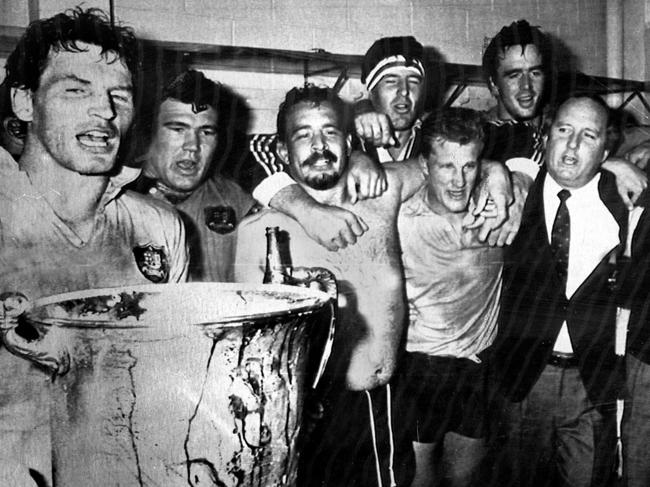 Aust Wallabies celebrate victory vs NZ All Blacks (L-R) Simon Poidiven, Tom Lawton, Enrique Rodriguez, Ross Reynolds, Michael Lynagh, Steve Cutler, coach Alan Jones & official Alec Evans celebrate with trophy as they sing Advance Australia Fair in dressing room in Auckland, 08 Sept 1986 : PicRoss/Setford /FotoPacific - sport Rugby Union team Picture: Supplied