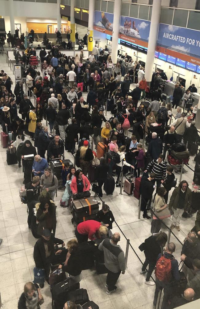 Queues of passengers wait for their turn at the check-in desks. Picture: AP 