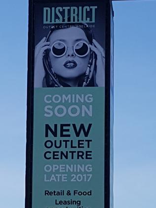 A sign promoting the District Outlet Centre to open late this year.