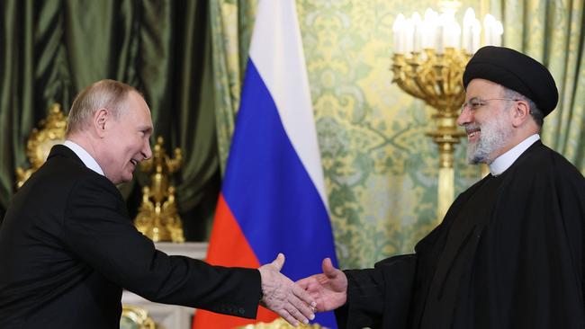 Russia's President Vladimir Putin shakes hands with Iran's President Ebrahim Raisi during their meeting in the Kremlin in Moscow.