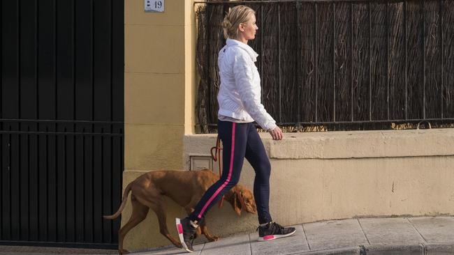 Odetta Chtouikite takes a stroll accompanied by her French breed dog.  Picture:  Hans Lucas Agency