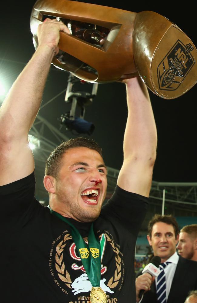 Sam Burgess celebrates with the premiership trophy.