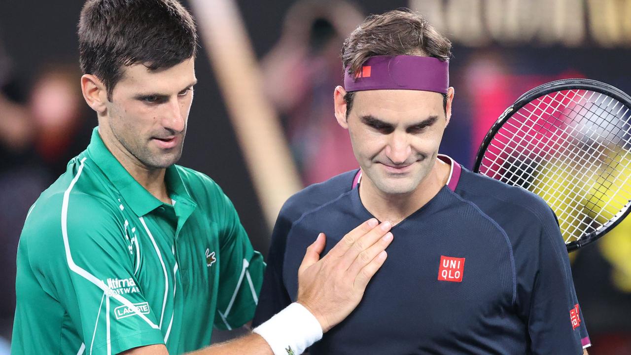 Serbia's Novak Djokovic pats Switzerland's Roger Federer.