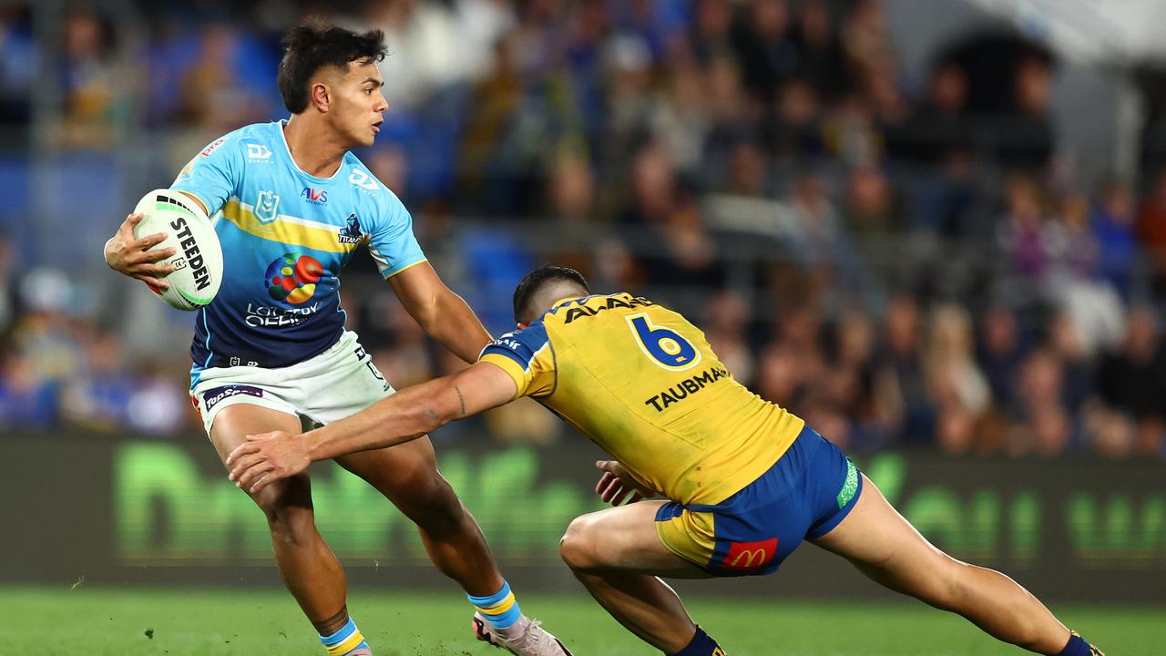 GOLD COAST, AUSTRALIA - JULY 13: Keano Kini of the Titans passes during the round 19 NRL match between Gold Coast Titans and Parramatta Eels at Cbus Super Stadium, on July 13, 2024, in Gold Coast, Australia. (Photo by Chris Hyde/Getty Images)