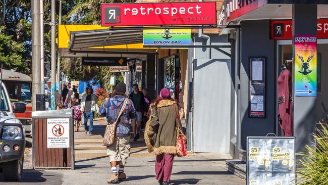 People walking past an art gallery in Byron Bay.