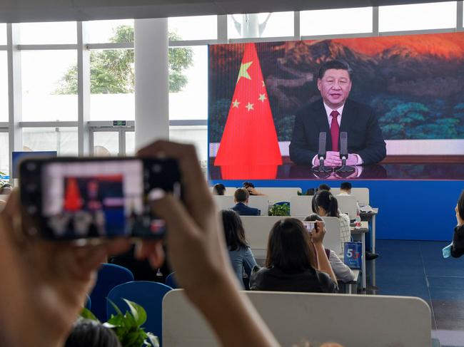 CORRECTION / Journalists watch a screen showing China's President Xi Jinping delivering a speech during the opening of the Boao Forum for Asia (BFA) Annual Conference 2021 in Boao, south China's Hainan province on April 20, 2021. (Photo by STR / AFP) / China OUT / âThe erroneous mention[s] appearing in the metadata of this photo by STR has been modified in AFP systems in the following manner: [removes 'LIVE IMAGE' from caption]. Please immediately remove the erroneous mention[s] from all your online services and delete it (them) from your servers. If you have been authorized by AFP to distribute it (them) to third parties, please ensure that the same actions are carried out by them. Failure to promptly comply with these instructions will entail liability on your part for any continued or post notification usage. Therefore we thank you very much for all your attention and prompt action. We are sorry for the inconvenience this notification may cause and remain at your disposal for any further information you may require.â