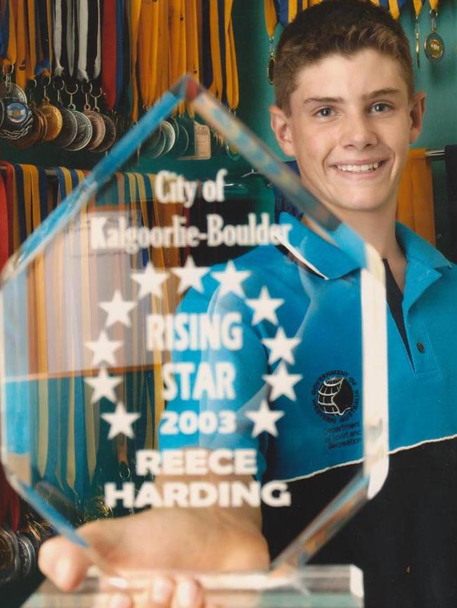 A young Reece Harding with a swimming trophy when he lived in Western Australia.