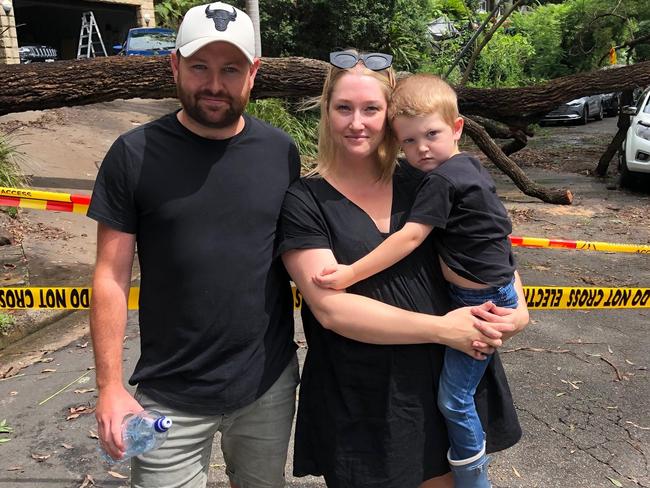 Steven and Ashlee Dowdall and Memphis, 4, in front of Kookaburra Cl, Bayview, where six homes were evacuated on Sunday due to fears of a landslip. Picture: Jim O'Rourke.