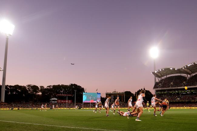 The Adelaide Oval lights shine over the Adelaide Crows and Fremantle Dockers in the Round 7 clash on Sunday. Picture: James Elsby/Getty