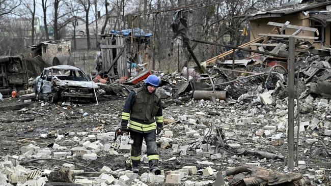 A rescuer among debris from a missile attack outside Kyiv. Picture: AFP