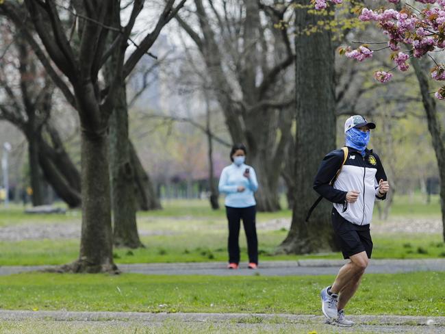 A New Yorker runs at a distance from other civilians. Picture: AP