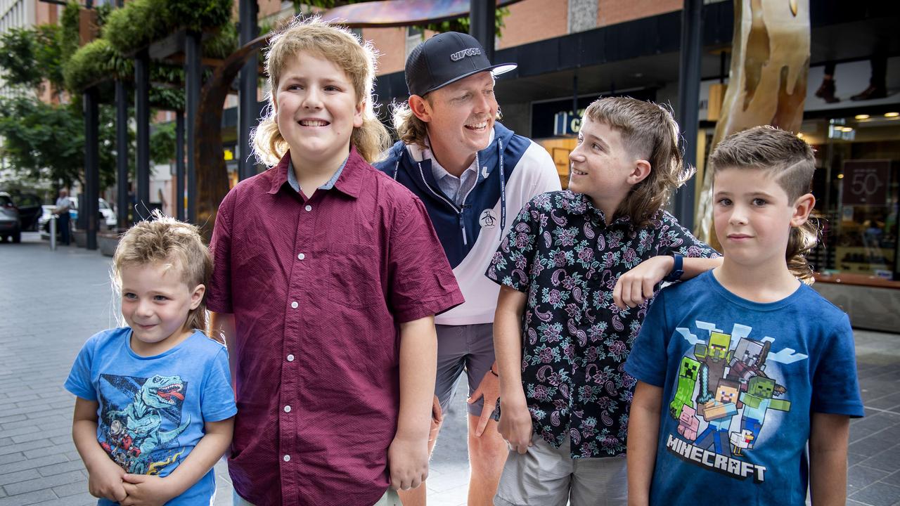 Cam Smith compares his mullet with young fans Hunter Fox, 4, Bradley Pearce, 10, Jack Cock, 11, and Lincoln Maddocks, 7, after his autograph session at the LIV Golf Fan Engagement Zone in Rundle Mall. Picture: Mark Brake