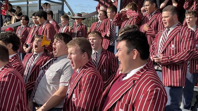 Ipswich Grammar School supporters cheer.