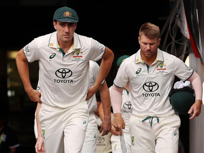 MELBOURNE, AUSTRALIA - DECEMBER 26: Pat Cummins of Australia walks out onto the field alongside teammate David Warner prior to day one of the Second Test Match between Australia and Pakistan at Melbourne Cricket Ground on December 26, 2023 in Melbourne, Australia. (Photo by Robert Cianflone/Getty Images)