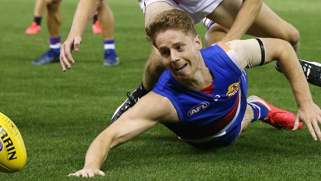 AFL Round 1. Western Bulldogs v Collingwood at Marvel Stadium..  21/03/2020.   Lachie Hunter of the Bulldogs battles at ground level with Will Hoskin-Elliott of the Magpies   . Pic: Michael Klein