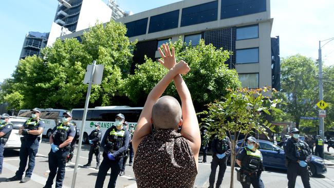 Supporters wave to a group of refugees at the hotel. Picture: Andrew Henshaw