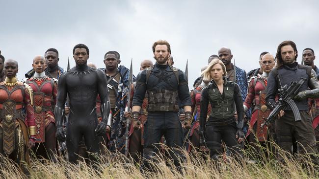 This image released by Marvel Studios shows, front row from left, Danai Gurira, Chadwick Boseman, Chris Evans, Scarlett Johansson and Sebastian Stan in a scene from "Avengers: Infinity War," premiering on April 27. (Chuck Zlotnick/Marvel Studios via AP)