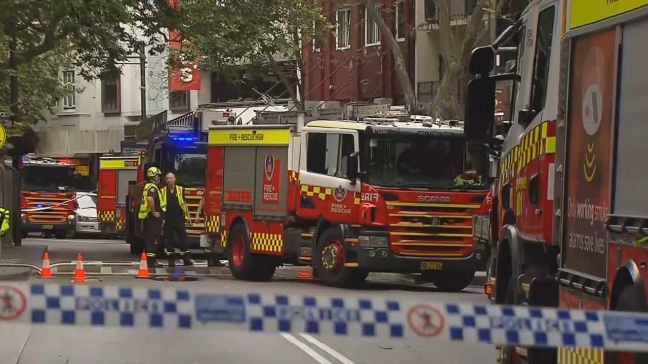 Backpackers flee to safety after a Sydney hostel catches fire