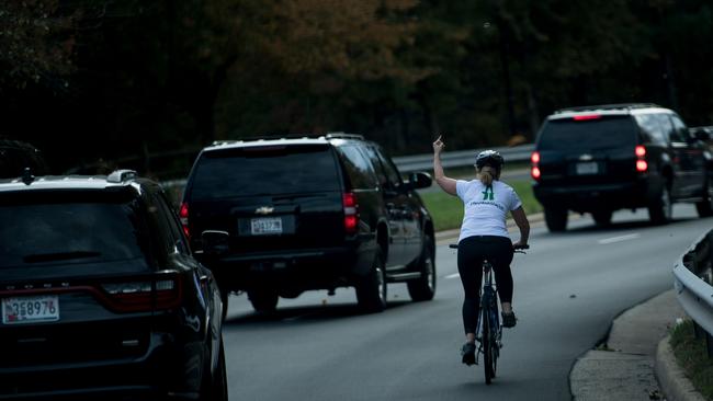 Juli Briskman gestures with her middle finger at a motorcade containing US President Donald Trump in Sterling, Virginia. The obscene gesture, captured on October 28, quickly went viral. Picture: Brendan Smialowski/AFPSource:AFP