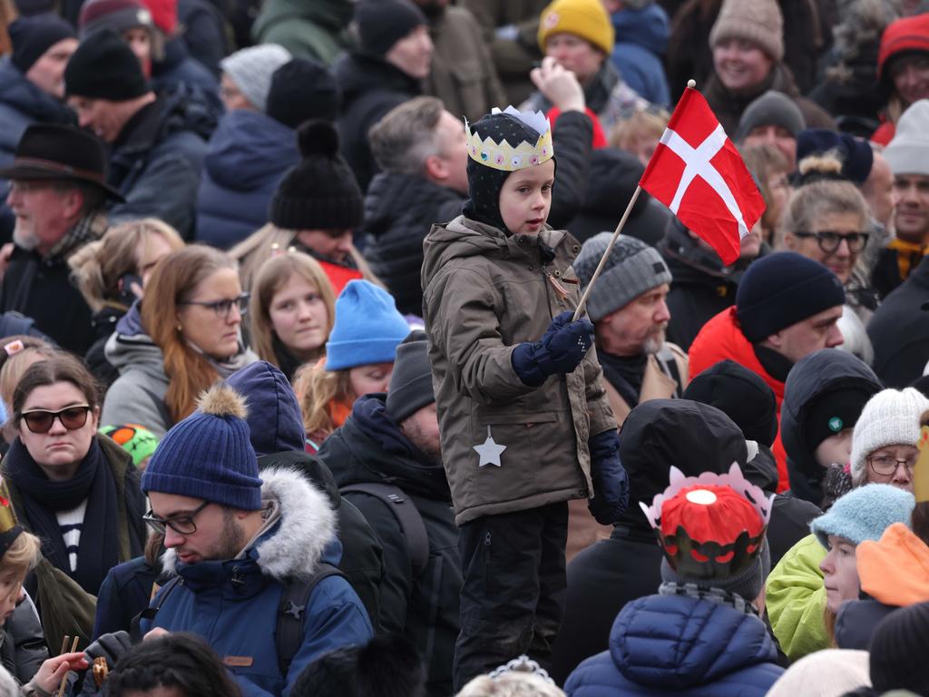 A child wearing a crown holds a Danish flag outside Christiansborg Palace. Picture: Sean Gallup/Getty Images