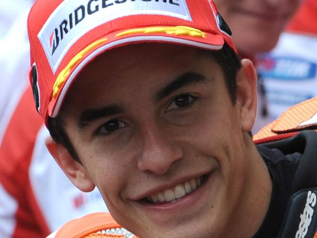 Spain's rider Marc Marquez (Repsol Honda N°93) poses after he clocked the pole position during the qualifying practice session of the MotoGP Grand Prix, on May 16, 2015 in Le Mans, western France, ahead of the MotoGP French Grand Prix. AFP PHOTO / JEAN FRANCOIS MONIER