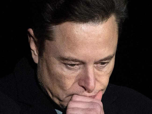 (FILES) In this file photo taken on February 10, 2022 Elon Musk pauses and looks down as he speaks during a press conference at SpaceX's Starbase facility near Boca Chica Village in South Texas. - Tesla Chief Executive Elon Musk courted dual controversies February 17, 2022, accusing a US regulator of trying to stifle his speech while drawing condemnation for comparing Canada's leader to Hitler. (Photo by JIM WATSON / AFP)