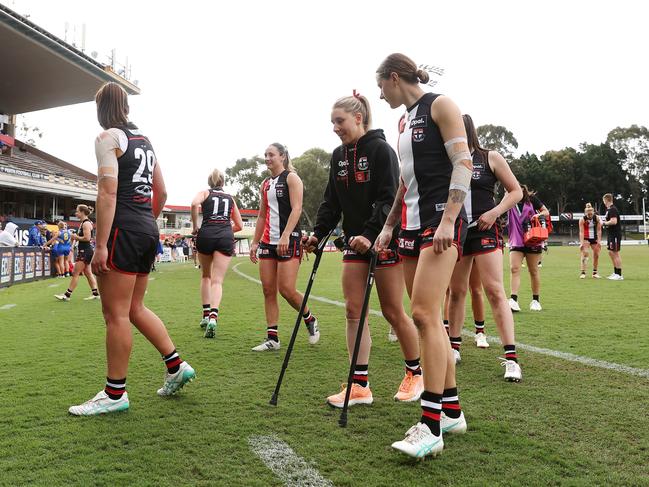 Hannah Priest leaves the field on crutches. Picture: Will Russell/AFL Photos via Getty Images