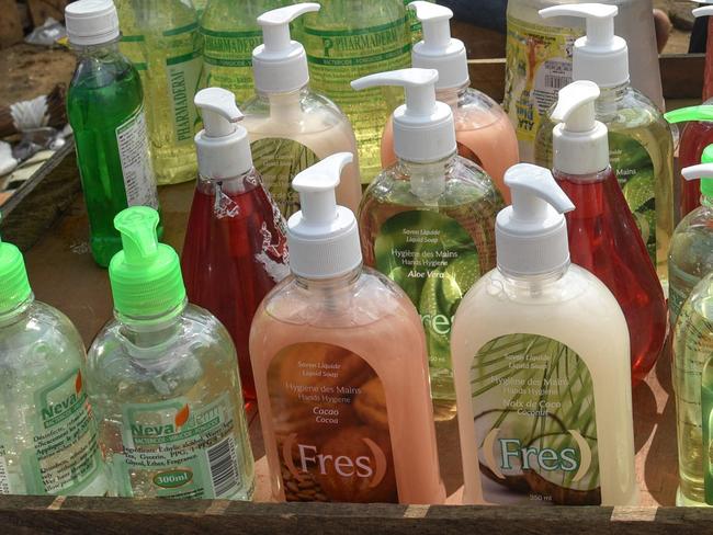 A street vendor sells soap and hand sanitiser amid the outbreak of COVID-19 (novel coronavirus), on March 27, 2020, in the working class area of Abobo, in Abidjan. - Ivory Coast onMarch 27 has registered 101 COVID-19 cases. (Photo by Sia KAMBOU / AFP)