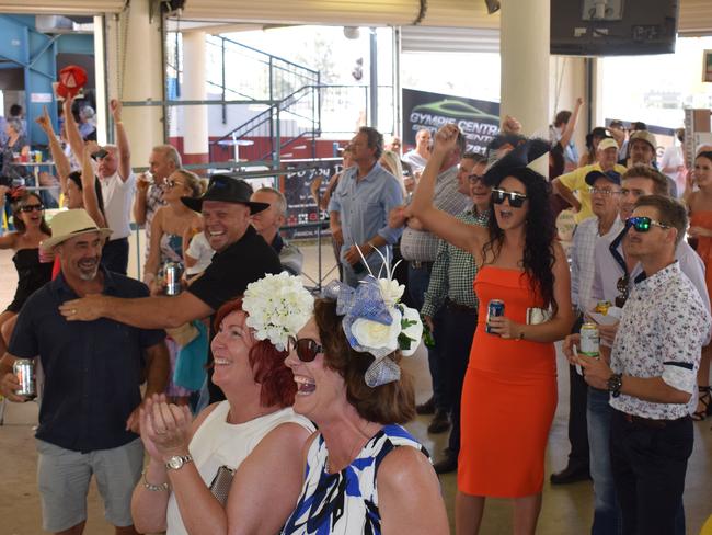 A small but boisterous crowd roar on Vow and Declare to the tight win at the Gympie Turf Club yesterday.