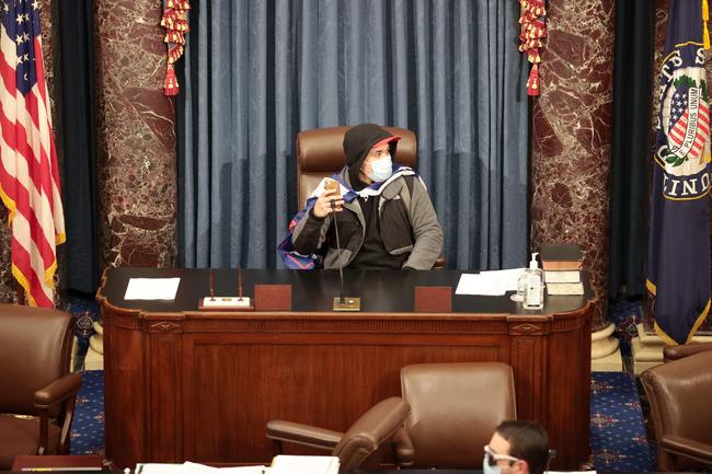 WASHINGTON, DC: A protester sits in the Senate Chamber. Picture: WIN MCNAMEE / GETTY IMAGES NORTH AMERICA / AFP)