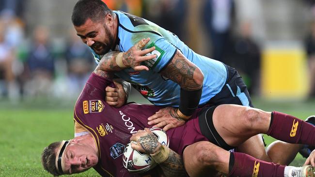 Andrew Fifita of the NSW Blues tackles Josh McGuire of the Queensland Maroons.