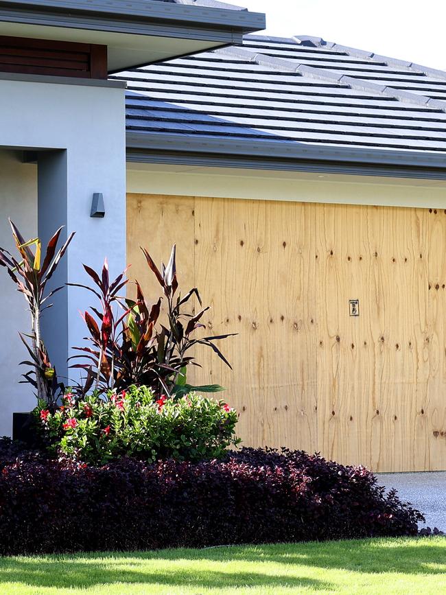 Marcelo Alcantara’s damaged roller door after cars were stolen. Pic: David Clark,