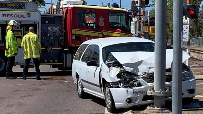 A car crash has blocked a busy intersection and halted a train this morning.