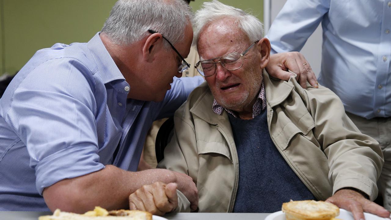 Scott Morrison comforts 85-year-old Owen Whalan at a Taree evacuation centre. Picture: Darren Pateman/AAP