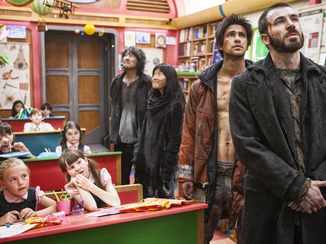 Chris Evans (far right) and Luke Pasqualino in a scene from film Snowpiercer